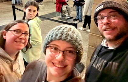 Family of four taking a selfie while enjoying the sights in Williamsburg. 