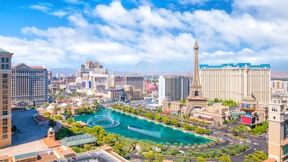Drone view of the Las Vegas Strip with the Bellagio Fountains and the Eiffel Tower at Las Vegas Resort & Casino in the distance.