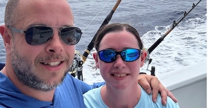 Picture of interior of the Church in Civita Castellana, featuring an altar in the foreground with frescos, ornate ceiling and walls in the background.