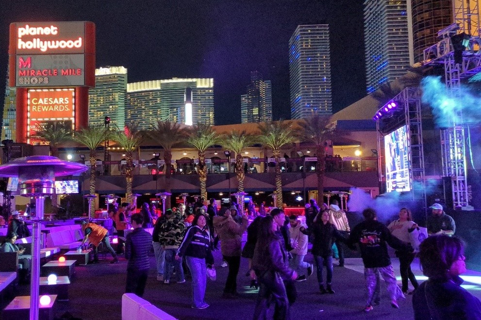 Crowd enjoying themselves at an evening even with Las Vegas hotels and casinos lit up in the background