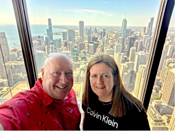 Smiling couple standing on the Skydeck in Willis Tower