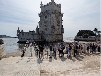 Couple and other visitors in front of Belem Tower in Portugal.