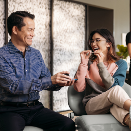 Teen girl and her male Invisalign® doctor laughing