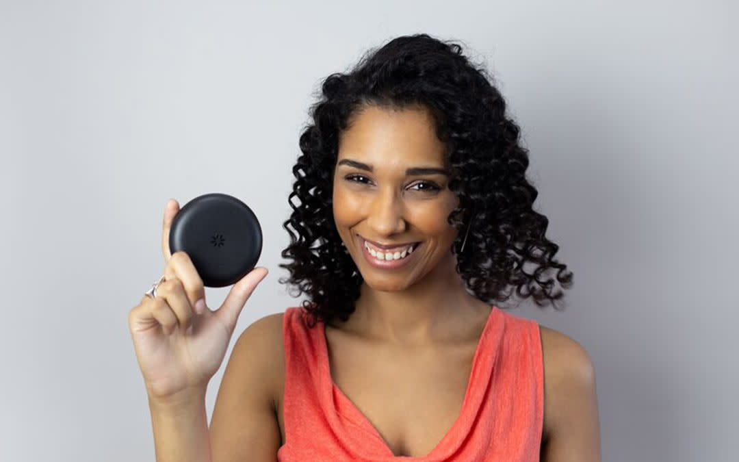Woman holding Invisalign case.