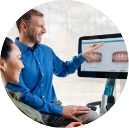 Invisalign® doctor showing his patient her new smile after using clear aligners