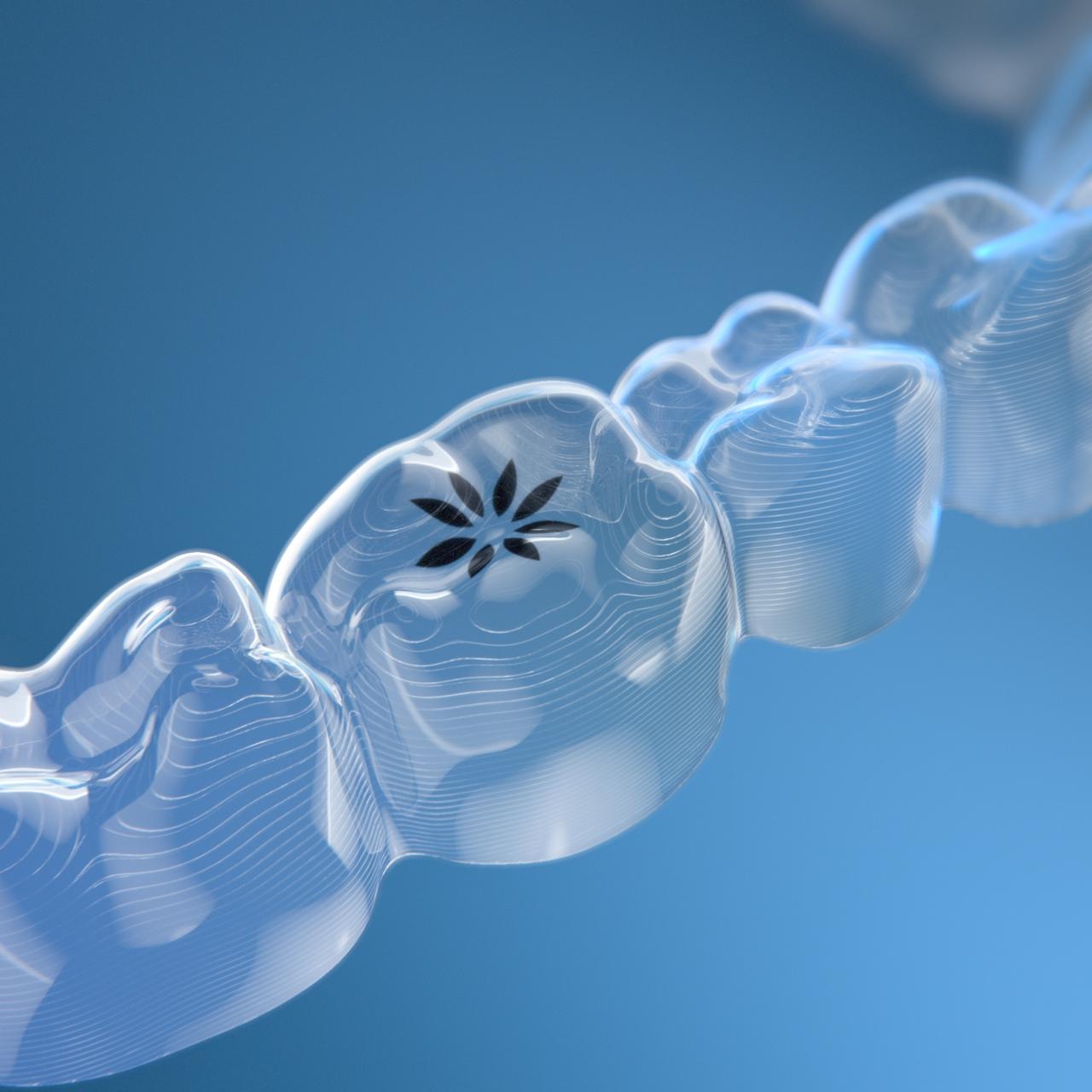 Sample of clear aligners on a blue background