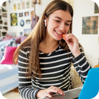 Girl smiling while studying with her clear aligner