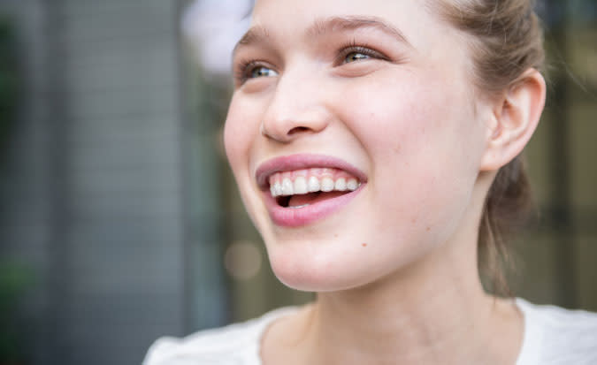 Woman smiling with Invisalign clear aligners