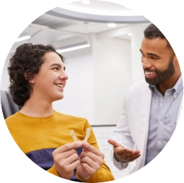 Teen checking his Invisalign® personalized treatment with doctor