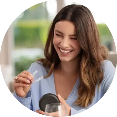 Woman takes her Invisalign® aligners out of their case