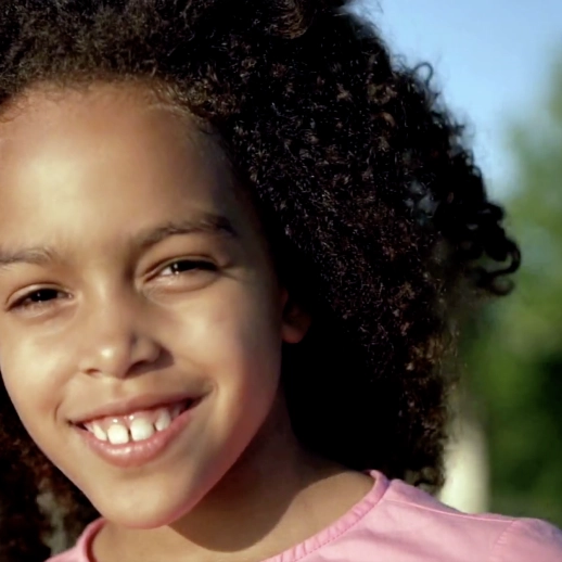 Black little girl smiling at the camera