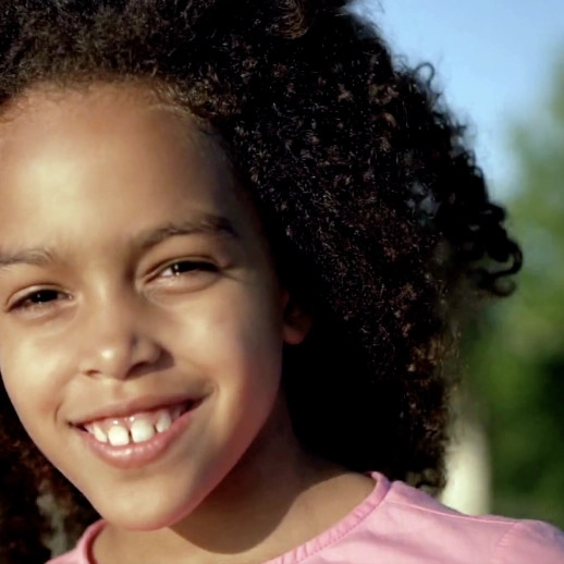 Black little girl smiling at the camera