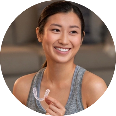 Young woman holding her Invisalign® aligners