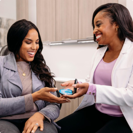 Female doctor giving Invisalign Aligners with case to female case