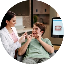 Female doctor explaining her patient how to use his Invisalign® aligners