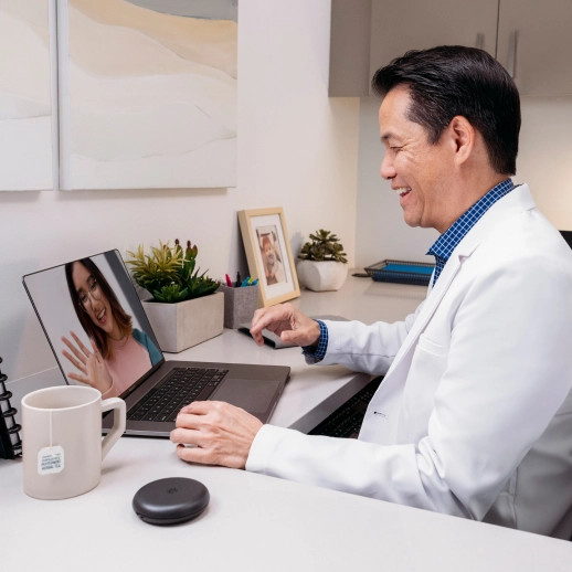 Invisalign® male doctor having a videocall with female patient