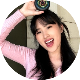 Young woman holding Invisalign aligners case and smiling