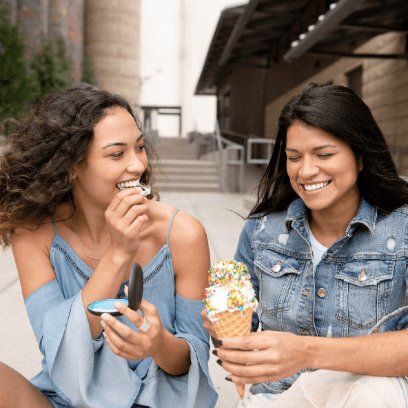 Woman putting in Invisalign clear aligners