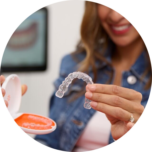 Woman taking Vivera™ retainers out of their case