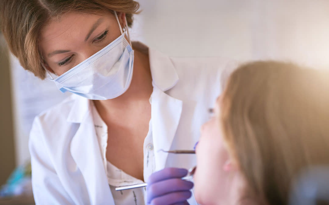 Dentist examining teenager’s teeth