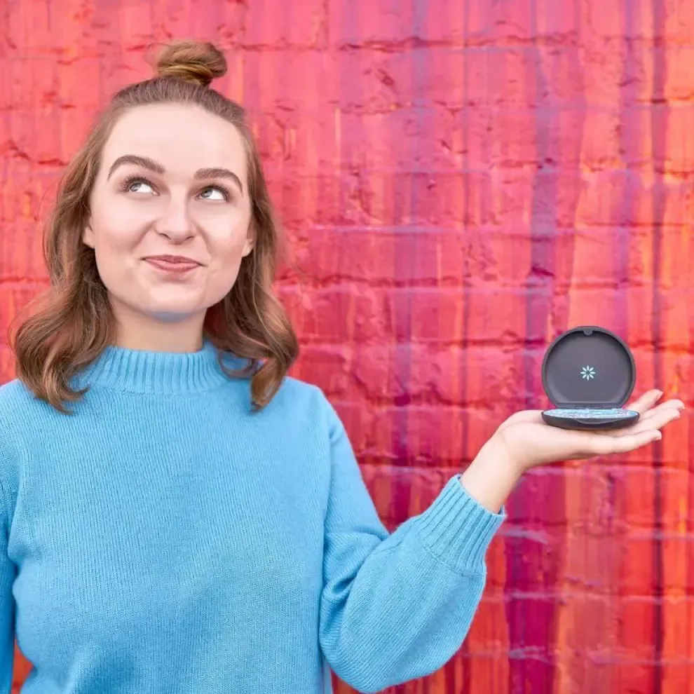 Teen girl holding Invisalign® clear aligners in their case