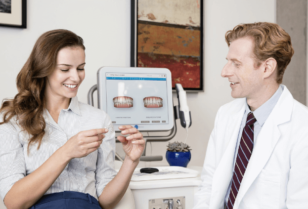 A doctor and patient discussing Invisalign treatment