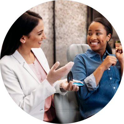 Female doctor showing her patient her Invisalign® aligners