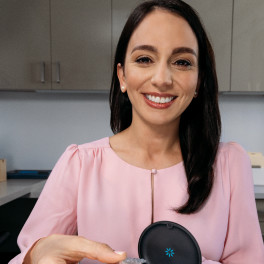 Invisalign young female doctor on a pink shirt smiling