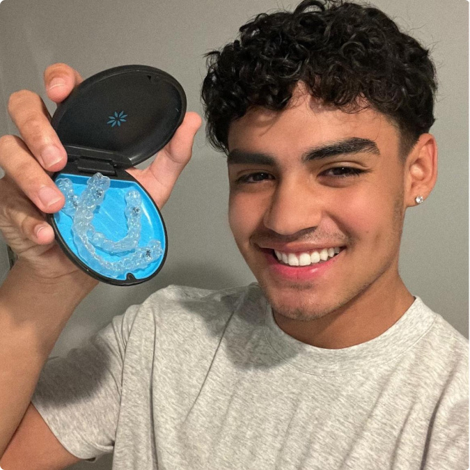 Teen boy sings to celebrate his Invisalign treatment., Invisalign®  aligners have helped more than 3 million teen smiles worldwide & counting.*  Book an appointment for Invisalign treatment today and help your