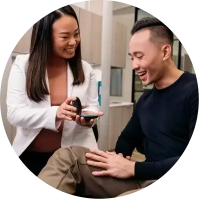 photo-3-up-female-doctor-showing-aligners-to-male-patient-black-shirt