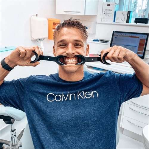 Guy in a dental practice, smiling