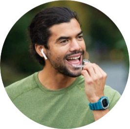 Man using his Invisalign® clear aligners while walking