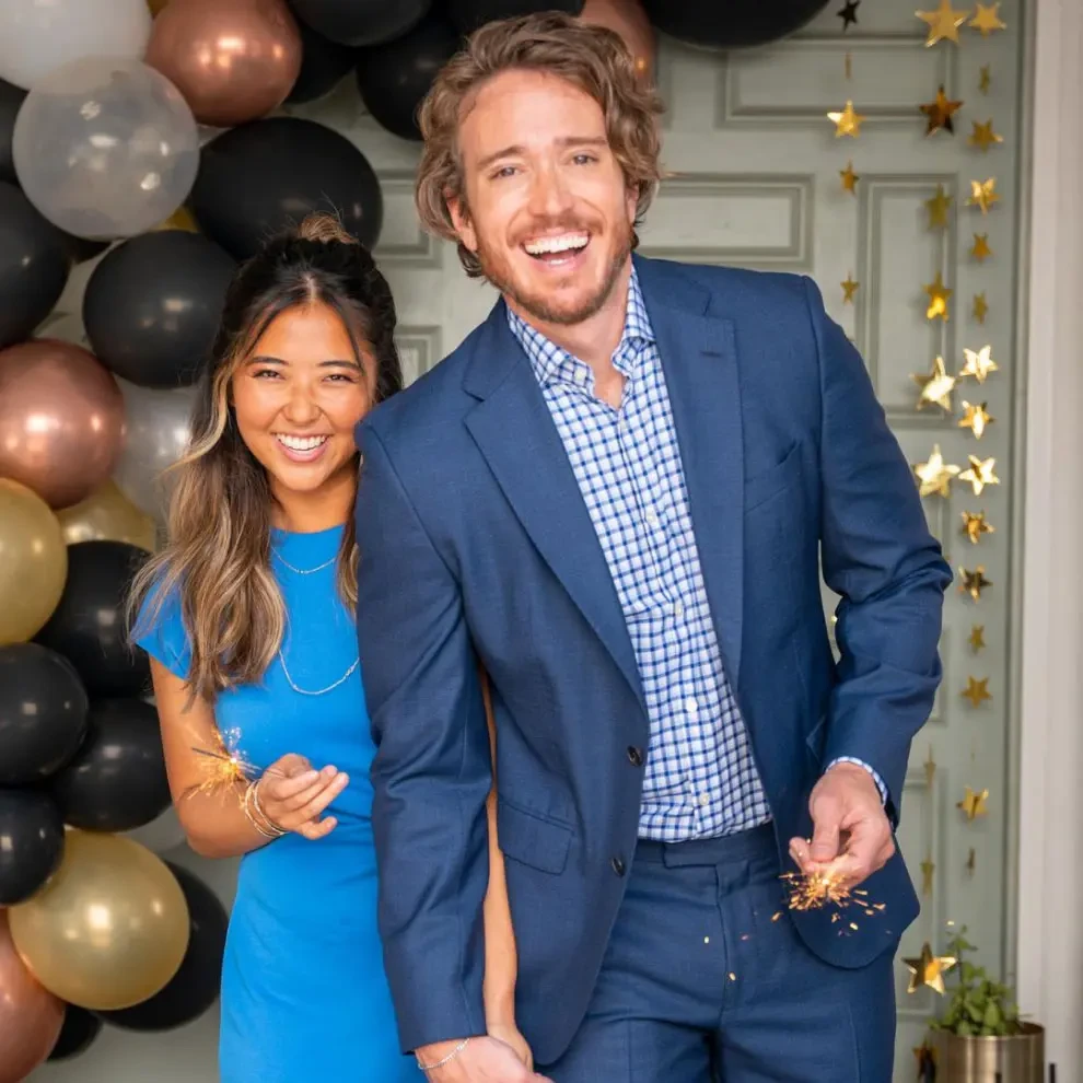 Couple smiling at a party with balloons happy for their Invisalign®​ results