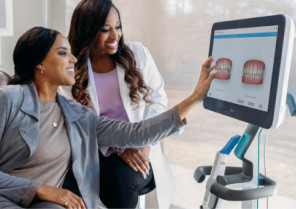 Female doctor showing her female patient her tooth's scan