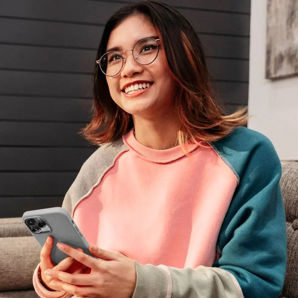 Teen smiling with her phone in her hands