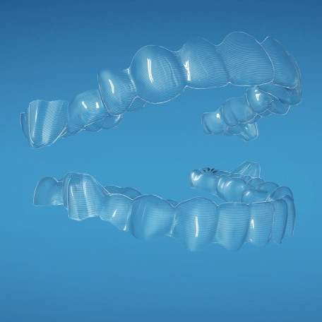 Two Invisalign® aligners forming a mouth shape on a blue background