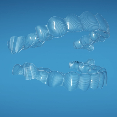 Two Invisalign® aligners forming a mouth shape on a blue background