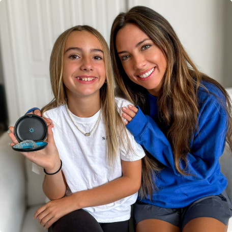 image-text-and-media-mother-and-daughter-showing-invisalign-aligners