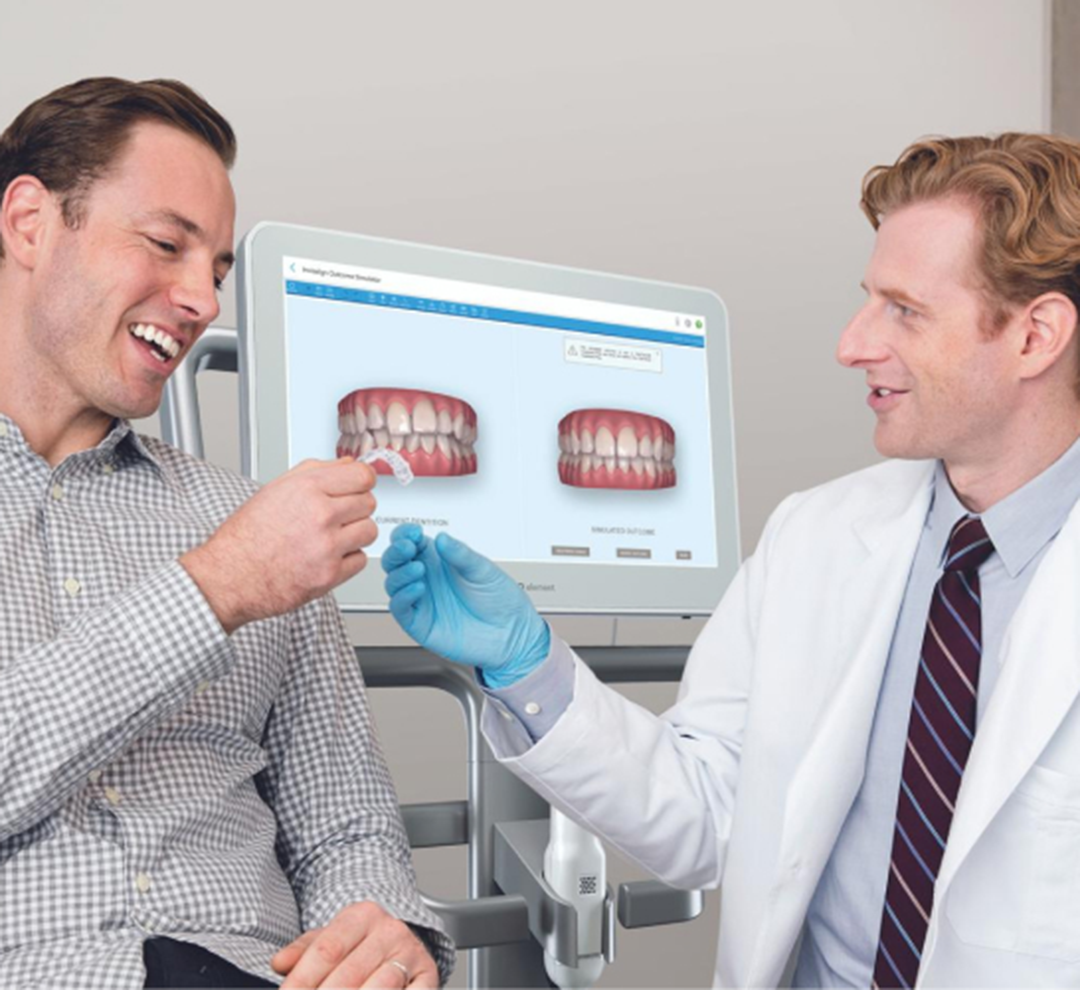 Invisalign® doctor gives the patient his Invisalign aligners in front of iTero scanner