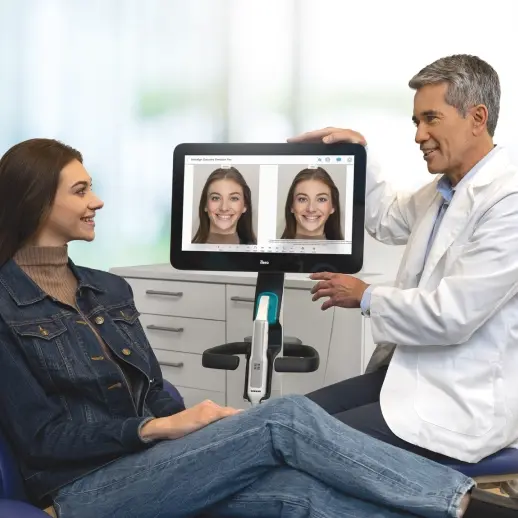 Invisalign® male doctor showing before and after smile pictures​ to his female patient