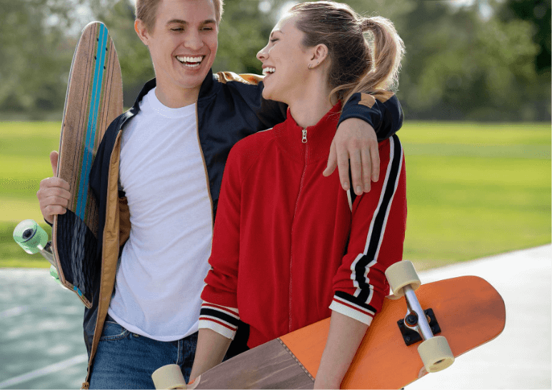Couple smiling happily wearing clear aligners