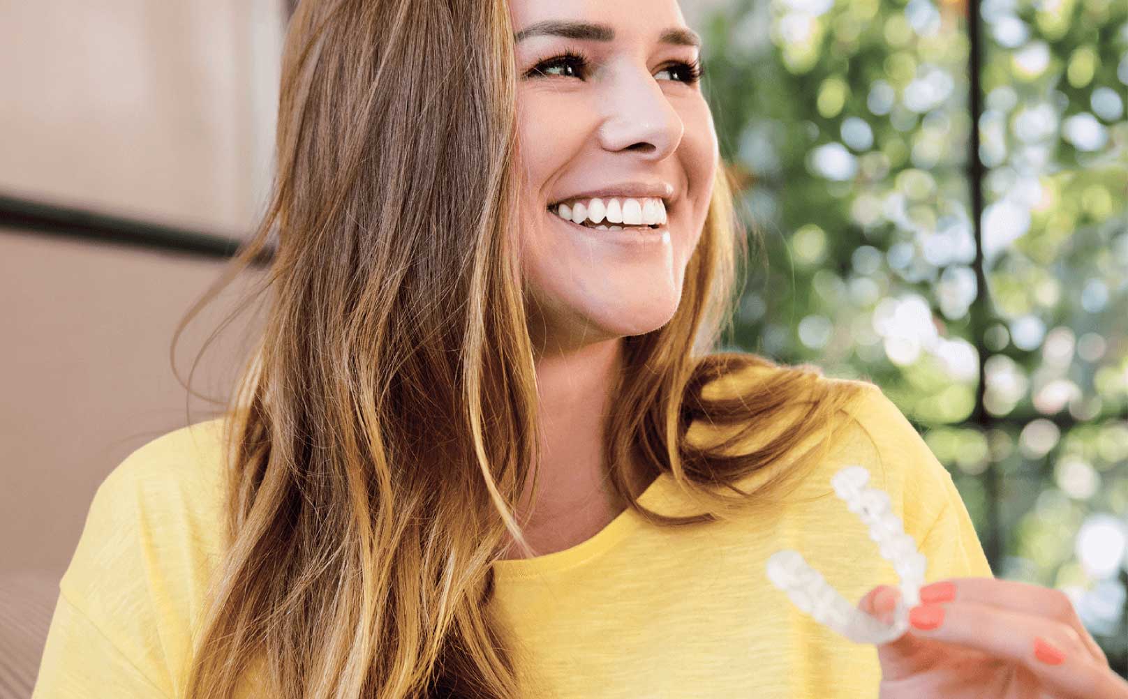 Girl smiling with her clear aligner