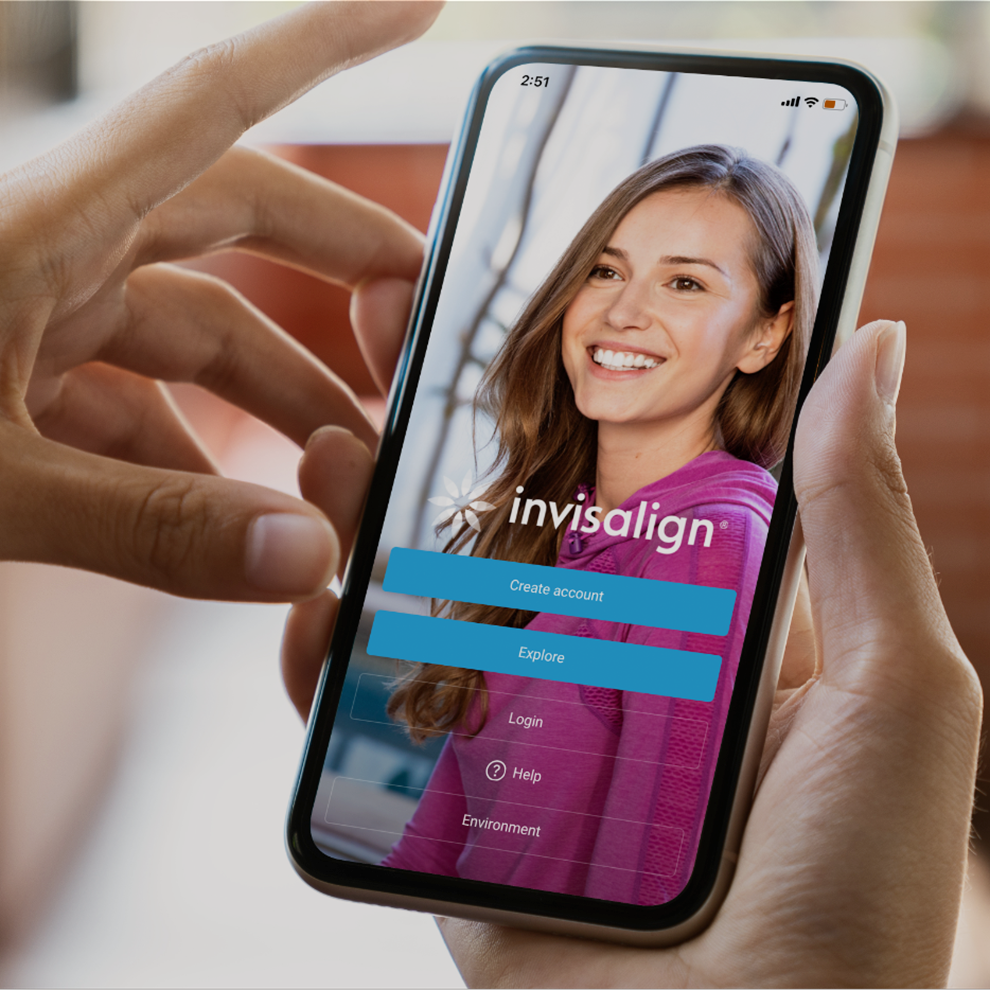 Phone in hands displaying homepage of Invisalign® Mobile App