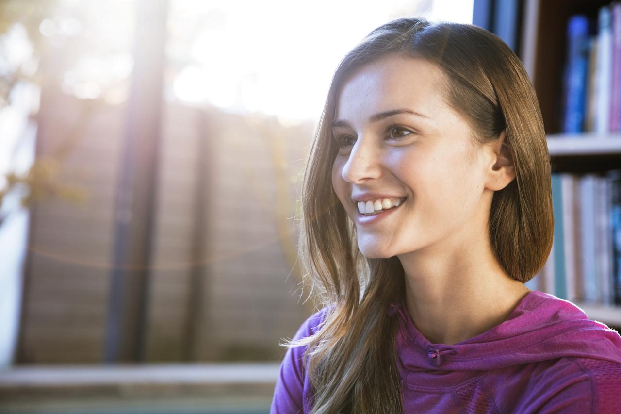 Girl in purple sweater smiling