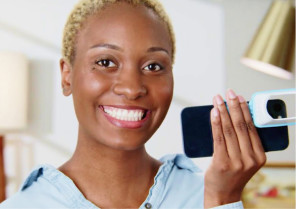 Female patient showing Invisalign lens via My Invisalign app for patients