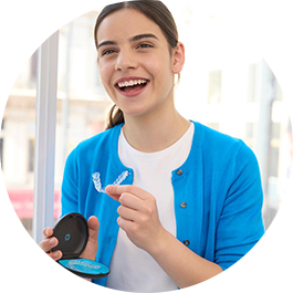 photo-3up-es-woman-in-blue-sweater-holding-aligners-and-case