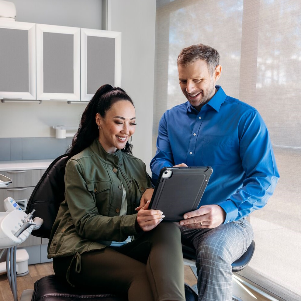 Young woman receives her aligners from a male doctor