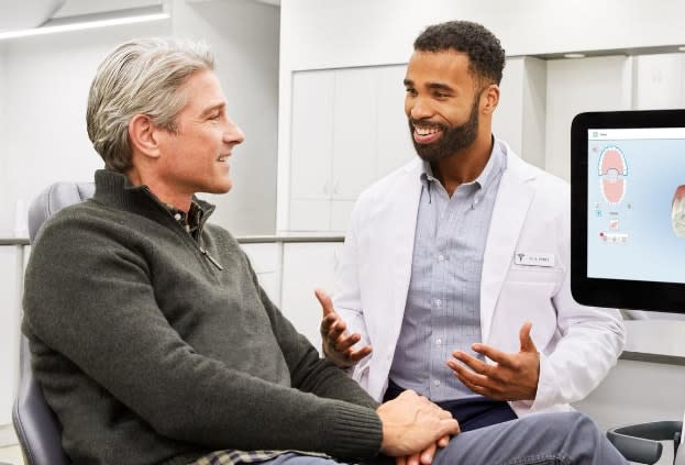 A doctor and patient discussing Invisalign treatment