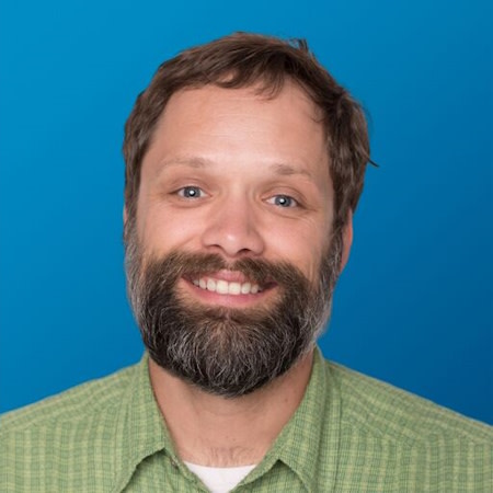 Man smiling after successful Invisalign® treatment