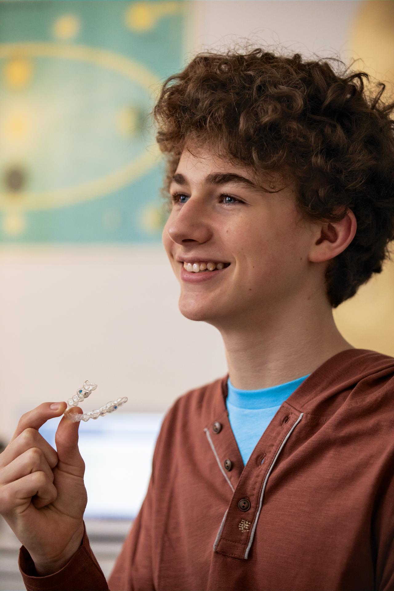 Young boy smile after Invisalign Treatment, instead of braces